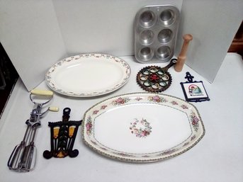 8 Piece Kitchenware Lot Of Vintage Platters, Iron Trivets, Muffinaire Pan, Flint Hand Egg Beater       A4