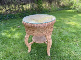 A Wicker Table With Glass Top