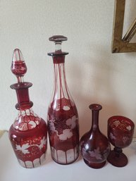 Four Pieces Of Bohemian Cranberry Etched Glass