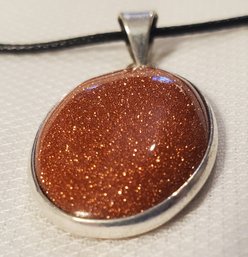 Silver Plated Goldstone Pendant 1 1/8' X 7/8' With A 16-18' Cloth Necklace