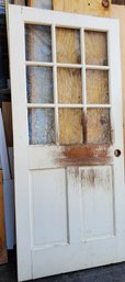 Nine Glass Pane Wood Door That Has Seen Some Damage From A Very Unhappy Dog