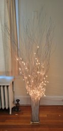 Illuminated White Twigs And A Glass Vase.          -           -           -             -        - Loc:2nd