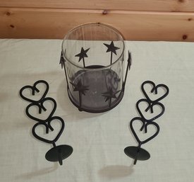 A Pair Of Metal Wall Sconces For Candles And A Glass Candle Holder