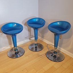 Trifecta Of Scoop Style Bar Stools In Electric Blue.