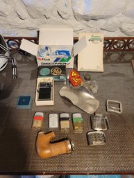 Zippos, Vintage GE Handheld Radio, Medallions,  And Some Other Mens Dresser Items.  - - -Loc: Under Wood Shlef