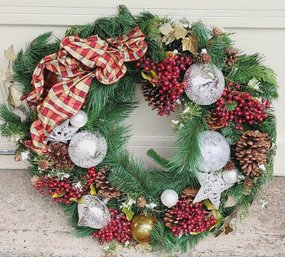 Christmas Wreath With Berries And Silver Ornaments And Plaid Bow