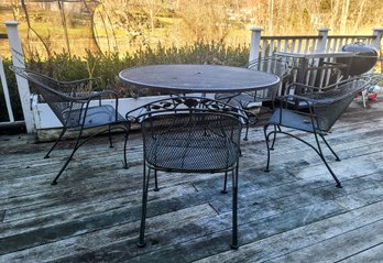 Four Metal Outdoor Arm Chairs And Round Table With Hole For Umbrella