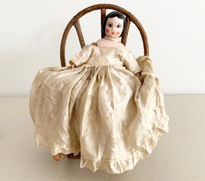 A Bisque Porcelain China Doll On Wood Chair