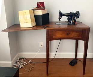 A Vintage Singer Sewing Table, Machine, And Accessories