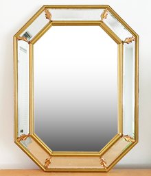 A Beveled Mirror Framed Mirror With Brass Trim