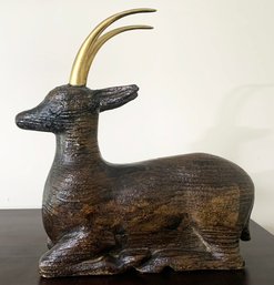 A Carved Deer With Brass Antlers