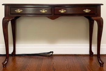 A Cherry Wood Console With Brass Hardware