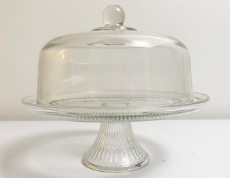 A Glass Pastry Stand With Cloche