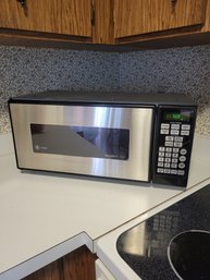G.E. Profile Stainless / Black Microwave.  Spacemaker II.  Tested And Working And Clean. - - - -Loc: G Shelf