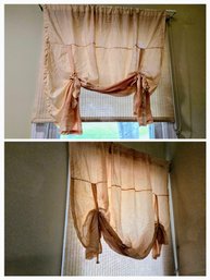 A Pair Of Soft Linen Fabric Roman Shades With A Rose Tint