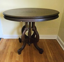 Sturdy Oval Shaped Antique Mahogany Victorian Parlor Table With Decorative Carved Base