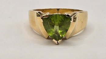 Trillion Cut Green Peridot Ring In A Wide 14 Karat Gold Band Setting