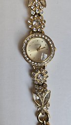 Guess Designer Crystal Jeweled Ladies Watch With Blooming Flower Design In Gold