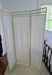 A Lovely White Wooden Screen With White Cotton Paneled Curtains