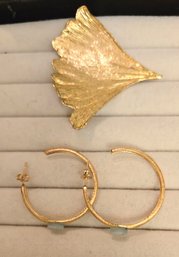 Brushed Gold Hoops With Raw Frosted Crystal Accent Paired With A Gold Ginkgo Leaf Pin