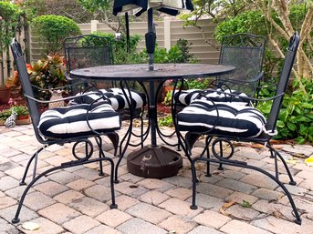 A Vintage Wrought Iron And Mesh Dining Table And Set Of 6 Chairs And Umbrella