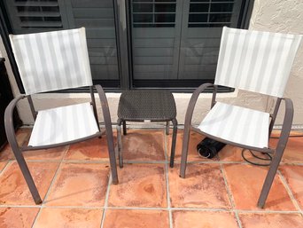 A Woven Acrylic Side Table And Pair Of Outdoor Chairs