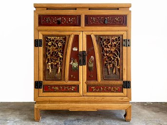A Vintage Chinese Console Cabinet With Carved Wood Paneled Doors