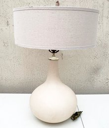 A Mid Century Modern Lamp With Drum Shade