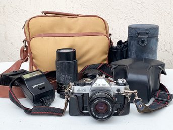 A Vintage Canon Camera, Multiples Lenses, And Accessories In Original Bag