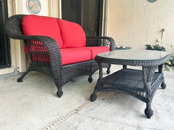 A Woven Acrylic Outdoor Loveseat And Coffee Table