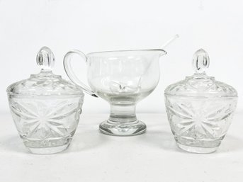 A Vintage Glass Gravy Pitcher With Ladle, And Pair Of Lidded Sugar Bowls