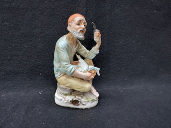 Ceramic Figure Of Man With Fish