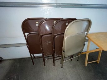 Four Metal Folding Chairs And A Folding Cocktail Table