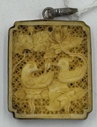 A CARVED CHINESE PENDANT MOUNTED IN SILVER