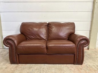 A Synthetic Leather Love Seat With Nailhead Detail