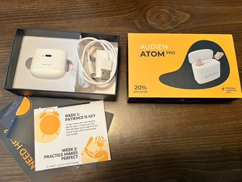 Audien Atom Pro Hearing Aid In It's Charger, Ready To Go