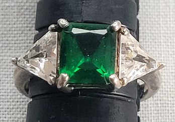 Gorgeous Emerald Colored Stone With Clear Crystal Triangular Side Details Set In Sterling Silver