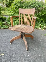 An Antique Oak Library Chair On Castors