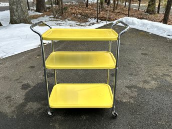 A Fantastic Yellow Enamel Three Tiered Cart On Casters