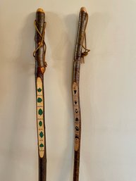 Two Carved Walking Sticks With Footprint & Leaf Guides