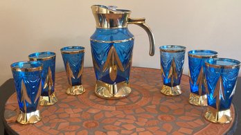 Vintage Ethpoian Blue Glass Carafe With Glasses And Terracotta Bistro Table