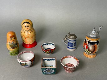A Collection Of Nesting Dolls, Mini Steins And Small Dishes