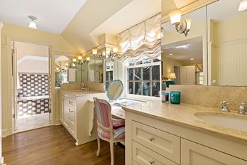 A Pair Of Custom Built In Stone Top Vanity With Makeup Desk