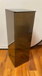 A Plexiglass Stand With Smoked Glass Top.