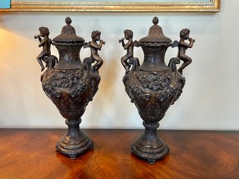 Pair Of Lidded Metal Urns With Cherubs, Paid $800