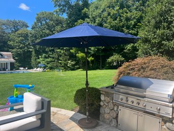 A 8.5' Dark Blue (tilt) Umbrella From California Umbrella  And Metal Weighted Stand