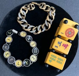 Three Vintage Bracelets: NINA RICCI Gold Plated Bracelet, Mahjong Stretch Bracelet, Typewriter Key Bracelet