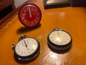 2 Stop Watches And Red Miniature Alarm Clock