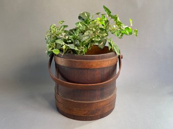 A Vintage Wooden Firkin Bucket With A Faux Plant