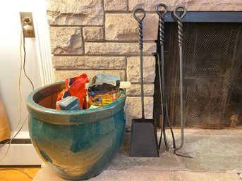 Black Iron Fireplace Tools And Planter Filled With Logs And Matches